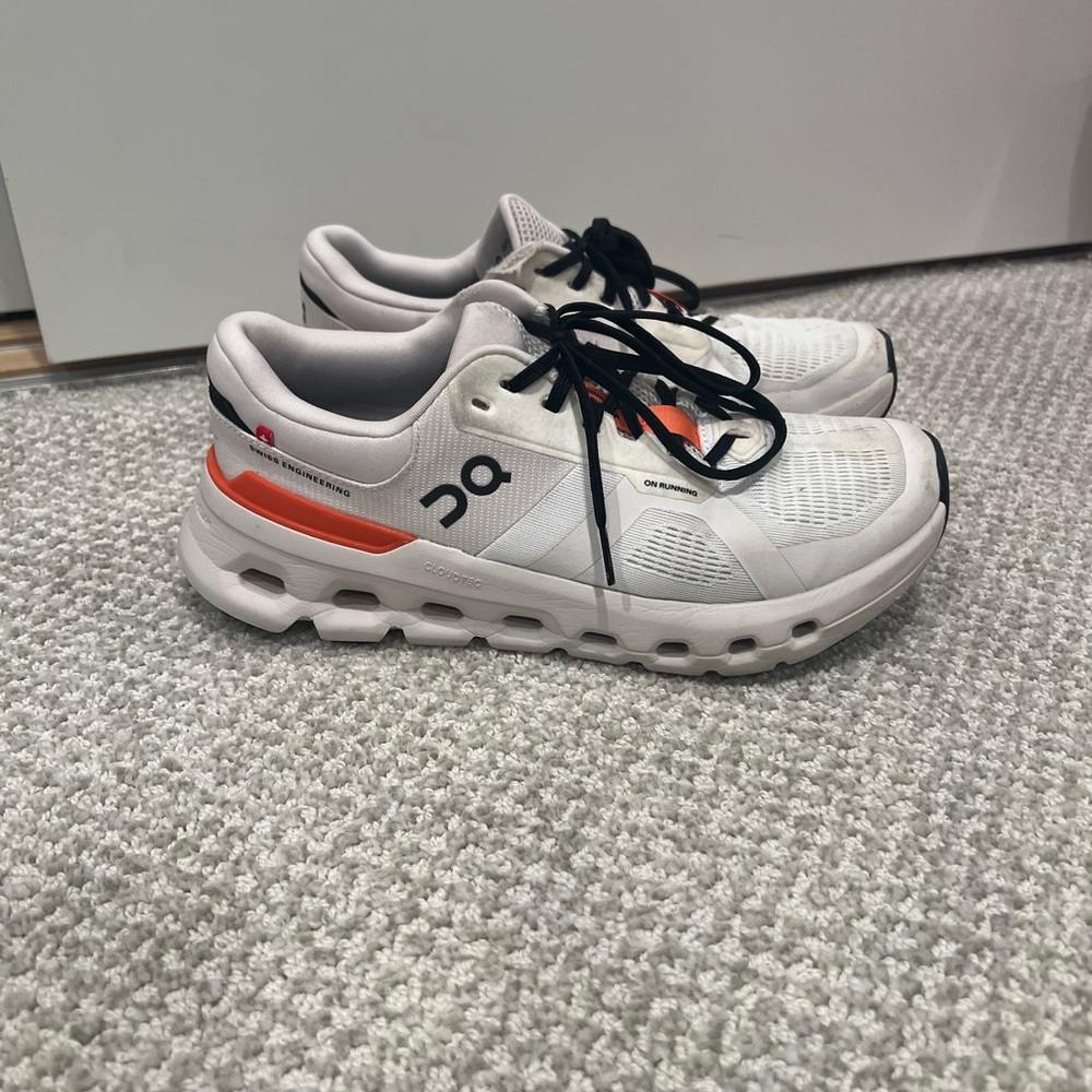 On Running White and Orange Sneakers with Chunky Sole and Sleek Design